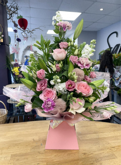 Warm Wishes - Send this vibrant hand-tied featuring a mix of favourite flowers delivered in a delightful gift bag or box is the perfect way to send your thoughts.